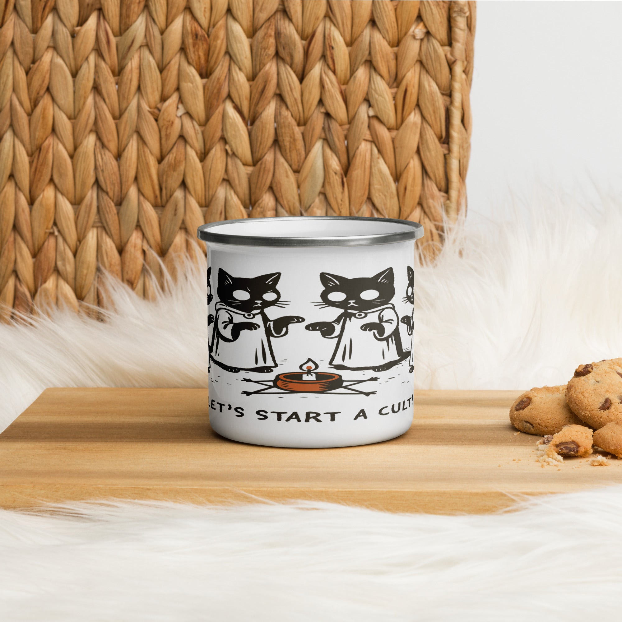 White enamel camp mug with black rim featuring illustrated robed cats gathered around a candle and the text “Let’s Start a Cult.”