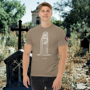 Man wearing a brown savana Solitary Embrace t-shirt with white line art of a skeleton cloaked in darkness, arms wrapped around itself, standing in a graveyard.