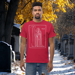 Man wearing a cardinal red Silent Vigil t-shirt with white line art of Death standing in a framed scene, graveyard path dusted with snow in the background.