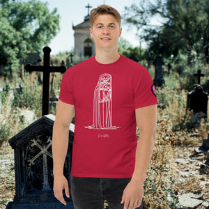 Man wearing a cardinal red Solitary Embrace t-shirt with white line art of a skeleton cloaked in darkness, arms wrapped around itself, standing in a graveyard.