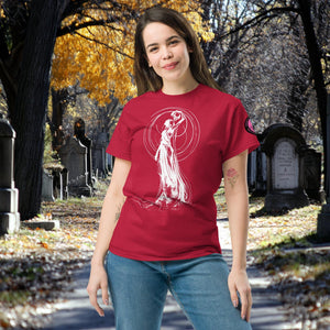 Woman wearing a cardinal red Wraith’s Reverie t-shirt with white line art of the Grim Reaper in graceful pose, surrounded by autumn trees and gravestones.