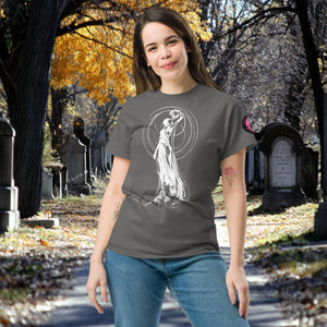 Woman wearing a charcoal front Wraith’s Reverie t-shirt with white line art of the Grim Reaper in graceful pose, surrounded by autumn trees and gravestones.