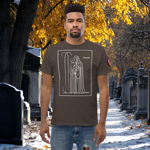Man wearing a dark chocolate Silent Vigil t-shirt with white line art of Death standing in a framed scene, graveyard path dusted with snow in the background.