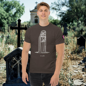 Man wearing a dark chocolate Solitary Embrace t-shirt with white line art of a skeleton cloaked in darkness, arms wrapped around itself, standing in a graveyard.