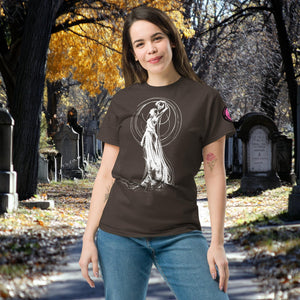 Woman wearing a dark chocolate Wraith’s Reverie t-shirt with white line art of the Grim Reaper in graceful pose, surrounded by autumn trees and gravestones.
