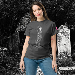 Woman wearing AETHEREUM CORPUS dark heather t-shirt with white line art corpse drawing, posed in a gothic graveyard.