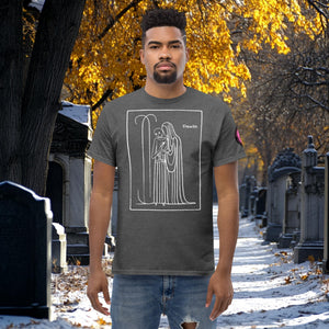 Man wearing a dark heather Silent Vigil t-shirt with white line art of Death standing in a framed scene, graveyard path dusted with snow in the background.