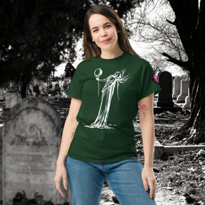 Woman wearing a forest green Phantom’s Waltz t-shirt with white line art of a ghostly figure holding a skull, standing in a graveyard with headstones behind her.