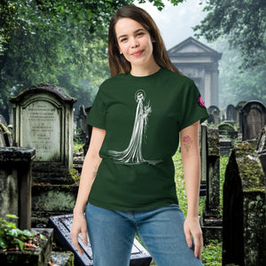 Man wearing a forest green Skeletal Serenity Classic Tee with white line art of Death holding flowers, standing in a gothic graveyard.