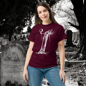 Woman wearing a maroon Phantom’s Waltz t-shirt with white line art of a ghostly figure holding a skull, standing in a graveyard with headstones behind her.