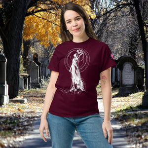 Woman wearing a maroon Wraith’s Reverie t-shirt with white line art of the Grim Reaper in graceful pose, surrounded by autumn trees and gravestones.