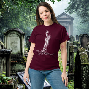 Man wearing a maroon Skeletal Serenity Classic Tee with white line art of Death holding flowers, standing in a gothic graveyard.