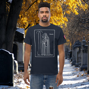 Man wearing a navy Silent Vigil t-shirt with white line art of Death standing in a framed scene, graveyard path dusted with snow in the background.