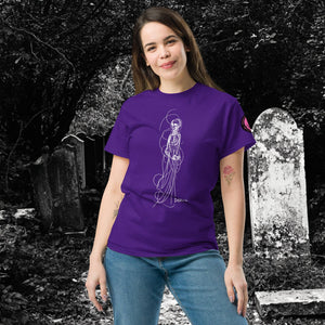 Woman wearing AETHEREUM CORPUS purple t-shirt with white line art corpse drawing, posed in a gothic graveyard.