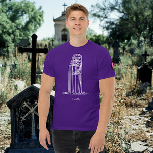 Man wearing a purple Solitary Embrace t-shirt with white line art of a skeleton cloaked in darkness, arms wrapped around itself, standing in a graveyard.