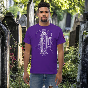 Man wearing a purple Arcane Guardian t-shirt with white skeletal line art and all-seeing symbol, standing in a sunlit graveyard.