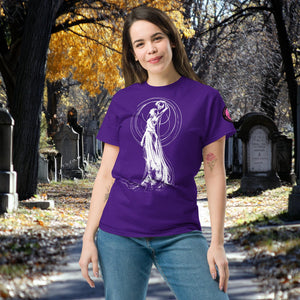 Woman wearing a purple Wraith’s Reverie t-shirt with white line art of the Grim Reaper in graceful pose, surrounded by autumn trees and gravestones.
