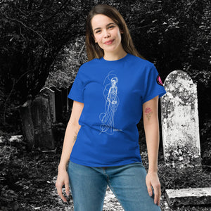 Woman wearing AETHEREUM CORPUS royal blue t-shirt with white line art corpse drawing, posed in a gothic graveyard.