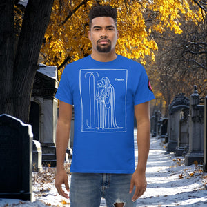 Man wearing a royal blue Silent Vigil t-shirt with white line art of Death standing in a framed scene, graveyard path dusted with snow in the background.