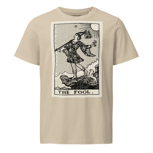 Mid-light organic cotton t-shirt featuring The Fool tarot card with cliff, dog, and sun in high-contrast woodcut rendering.