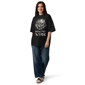 Black oversized organic cotton t-shirt featuring horned monster within ritual circle and fractured script background.