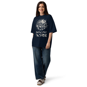 Black oversized organic cotton t-shirt featuring horned monster within ritual circle and fractured script background.