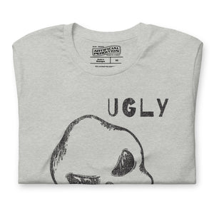 Crude hand-drawn skull with mismatched eye sockets and UGLY text in the upper corner, anti-polish graphic design, Artificial Perdition apparel