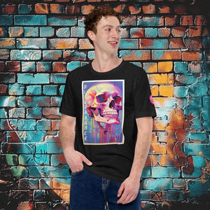 A man wearing a black heather Discordance Core Tee with vibrant skull dripping in color, standing before a blue and orange graffiti wall.