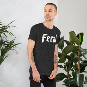 Feral in white blackletter font on dark heather grey t-shirt, bold single word graphic design, Artificial Perdition apparel
