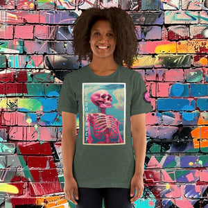 Woman wearing a heather forest Deconstruct Core Tee with colorful skeletal design gazing upward, standing before a vibrant graffiti wall.