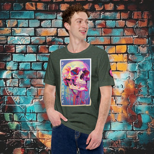 A man wearing a heathe forest Discordance Core Tee with vibrant skull dripping in color, standing before a blue and orange graffiti wall.