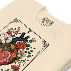 Tarot card illustration numbered X with an anatomical heart in bloom surrounded by wildflowers and vines, Amor Fati, Artificial Perdition apparel