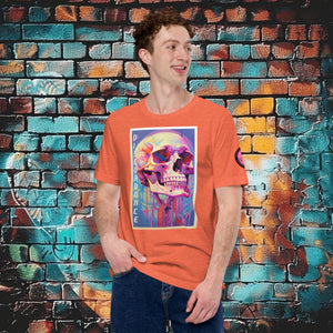 A man wearing an orange Discordance Core Tee with vibrant skull dripping in color, standing before a blue and orange graffiti wall.
