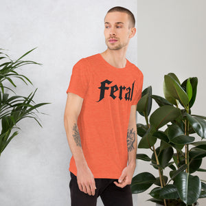 Feral in white blackletter font on dark heather grey t-shirt, bold single word graphic design, Artificial Perdition apparel