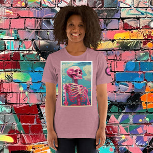 Woman wearing a heather orchid Deconstruct Core Tee with colorful skeletal design gazing upward, standing before a vibrant graffiti wall.
