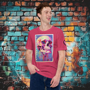 A man wearing a heather raspberry Discordance Core Tee with vibrant skull dripping in color, standing before a blue and orange graffiti wall.