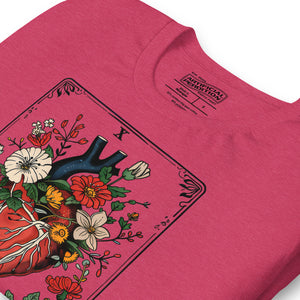 Tarot card illustration numbered X with an anatomical heart in bloom surrounded by wildflowers and vines, Amor Fati, Artificial Perdition apparelProduct mockup