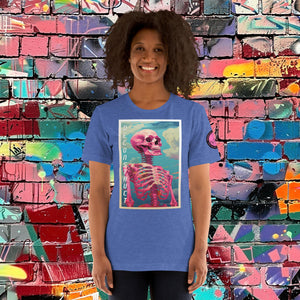 Woman wearing a heather true royal Deconstruct Core Tee with colorful skeletal design gazing upward, standing before a vibrant graffiti wall.