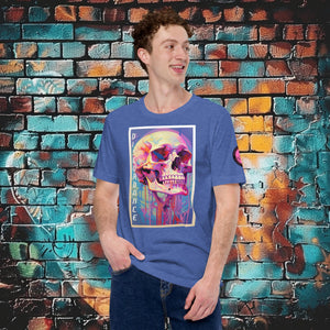 A man wearing a true royal Discordance Core Tee with vibrant skull dripping in color, standing before a blue and orange graffiti wall.