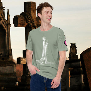 Man wearing a sage Skeletal Serenity Core Tee with minimalist Grim Reaper design, surrounded by weathered tombs and greenery.