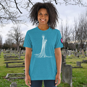 A woman wearing an aqua tri-blend Skeletal Serenity Premium Tee with elegant line art of Death holding flowers, sunset cemetery backdrop.