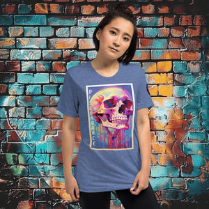 Woman wearing a blue triblend Discordance Premium Tee with surreal neon skull artwork against a colorful graffiti backdrop.