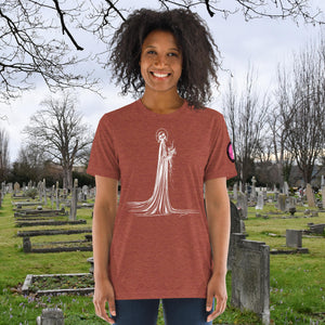 A woman wearing a clay tri-blend Skeletal Serenity Premium Tee with elegant line art of Death holding flowers, sunset cemetery backdrop.