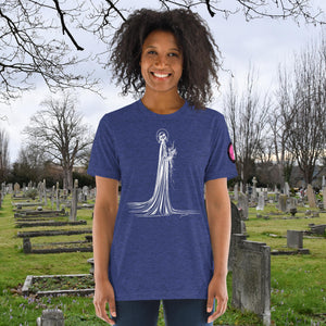 A woman wearing a navy tri-blend Skeletal Serenity Premium Tee with elegant line art of Death holding flowers, sunset cemetery backdrop.