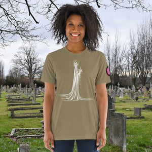 A woman wearing an olive tri-blend Skeletal Serenity Premium Tee with elegant line art of Death holding flowers, sunset cemetery backdrop.