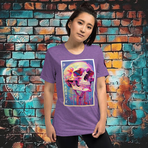 Woman wearing a purple triblend Discordance Premium Tee with surreal neon skull artwork against a colorful graffiti backdrop.
