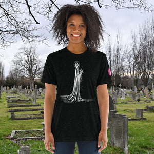 A woman wearing a solid black tri-blend Skeletal Serenity Premium Tee with elegant line art of Death holding flowers, sunset cemetery backdrop.