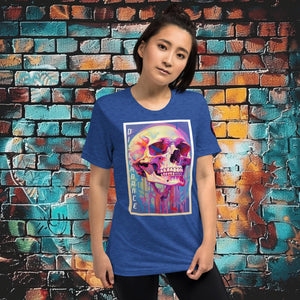 Woman wearing a true royal triblend Discordance Premium Tee with surreal neon skull artwork against a colorful graffiti backdrop.