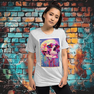 Woman wearing a white fleck triblend Discordance Premium Tee with surreal neon skull artwork against a colorful graffiti backdrop.