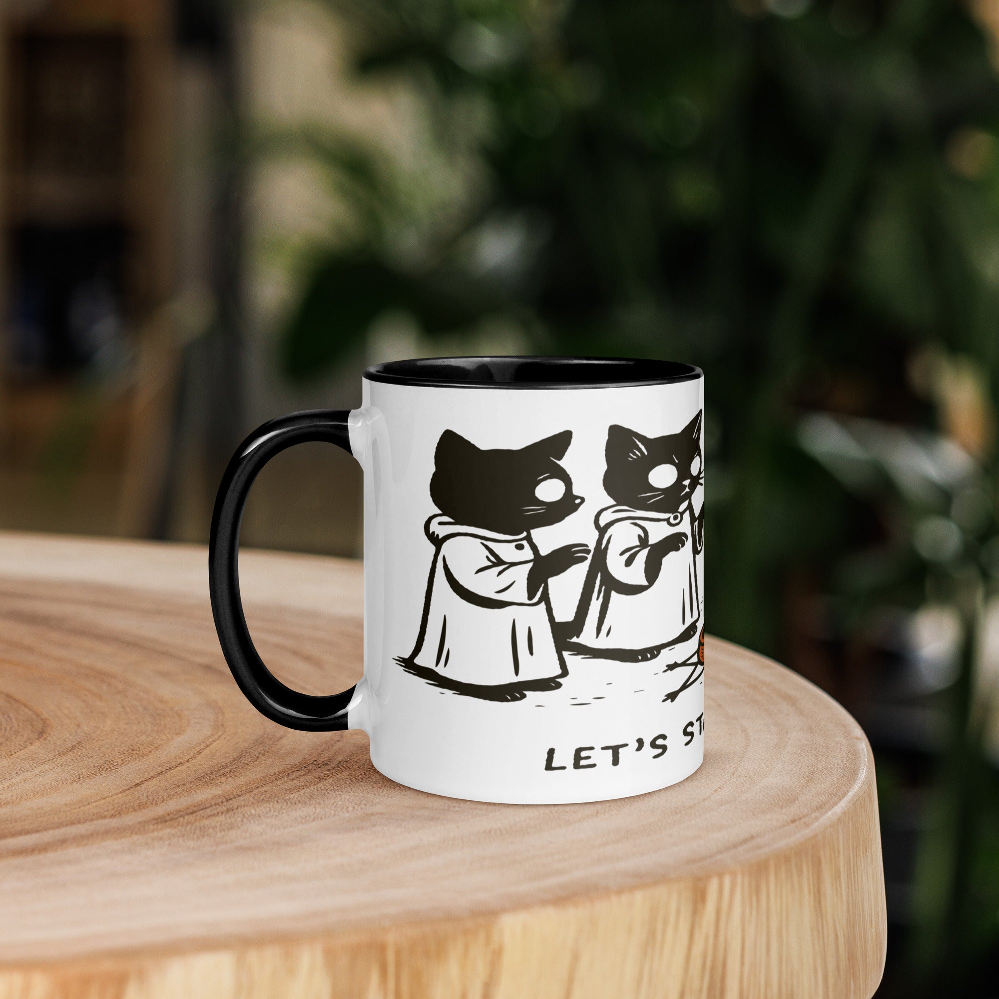 Color accent ceramic mug with contrasting rim and handle, featuring robed cats gathered around a candle and the text “Let’s Start a Cult.”